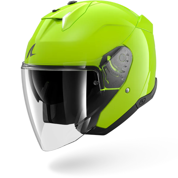 Green motorcycle helmet with a clear visor on a white background
