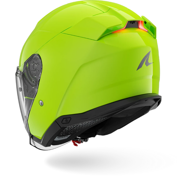 Green motorcycle helmet with clear visor on a white background