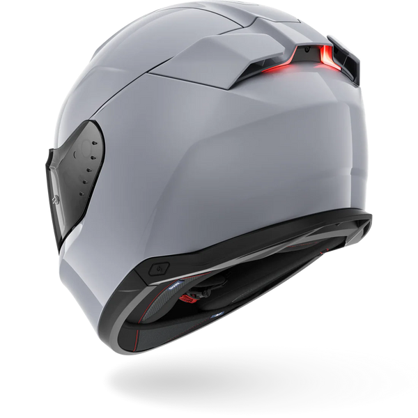 Gray motorcycle helmet with a red light on a white background