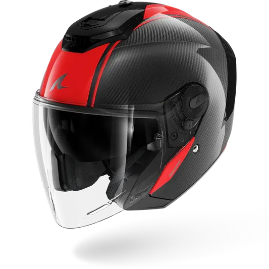 A carbon fiber full-face motorcycle helmet with red accents and a clear visor, shown floating against a white background.